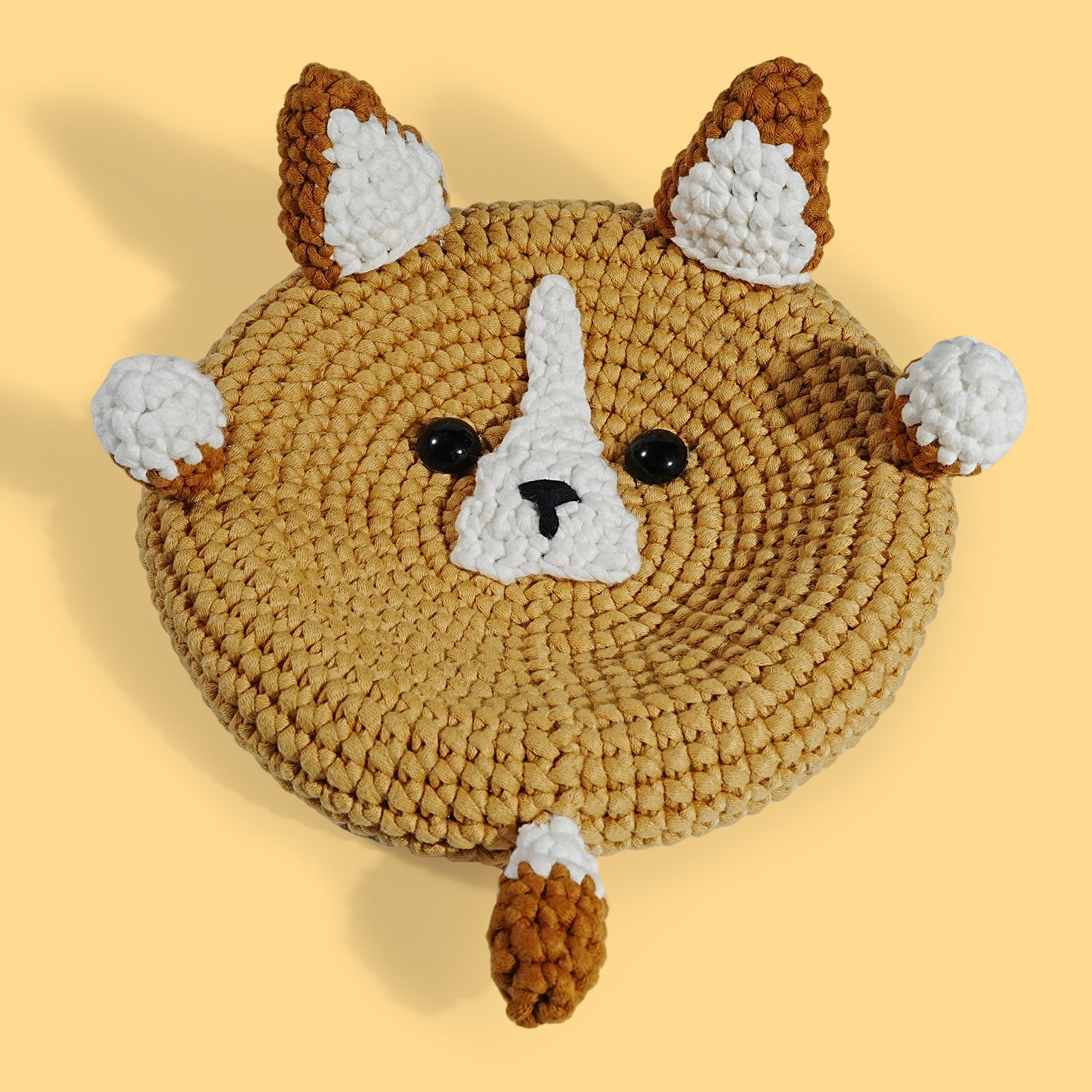 Handcrafted crochet corgi-shaped storage box in beige with a patterned design, featuring ears and a face on top.