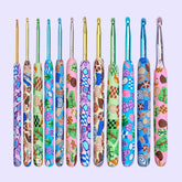A set of 12 colorful crochet hooks with a cartoon pattern on the handles, arranged in a row with the hooks facing up.