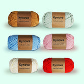 A collection of Kynova Premium Yarn skeins in various colors, each labeled with the brand name and the tagline 'Craft with Comfort'.