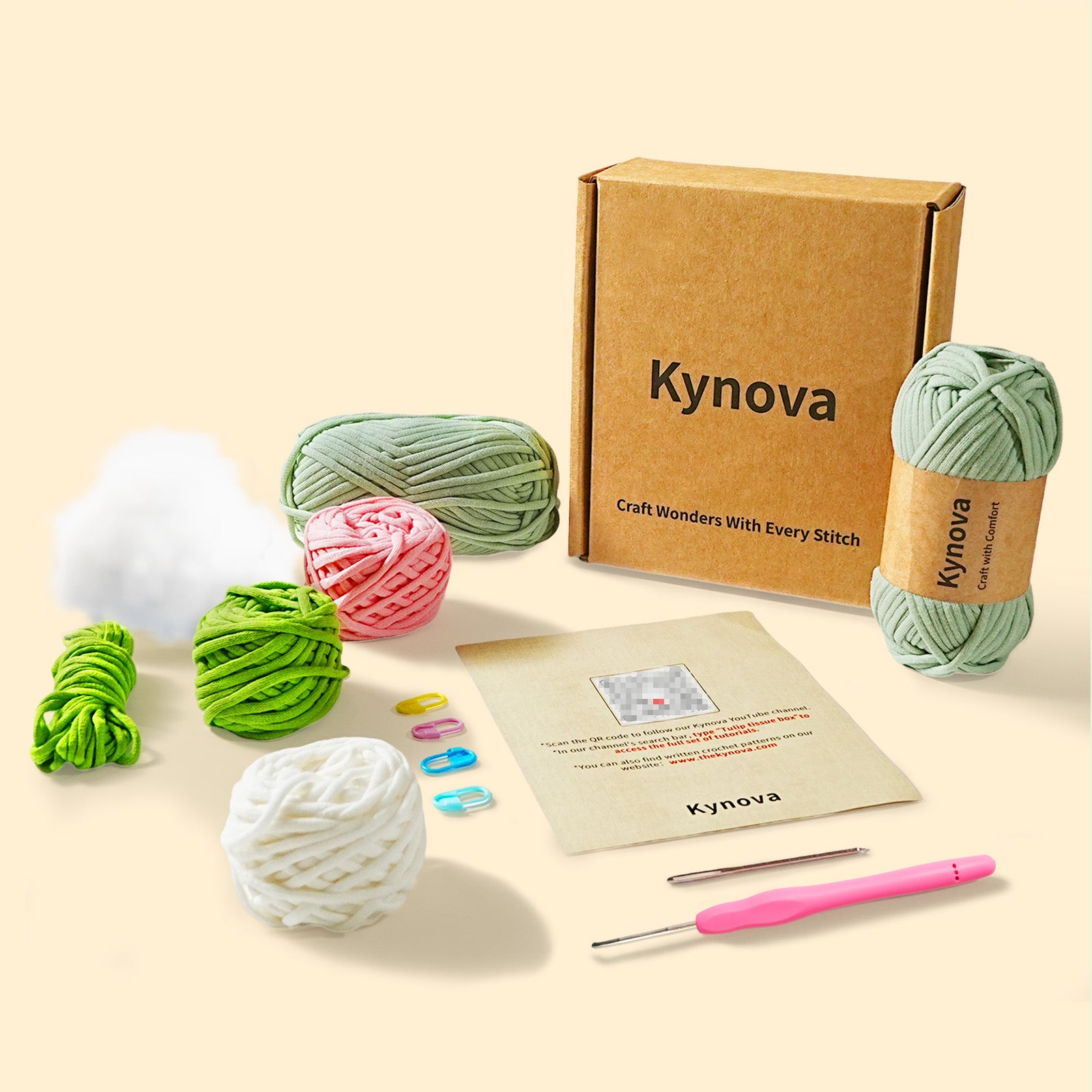 Kynova craft kit with yarn balls, a box, and crochet tools on a beige background