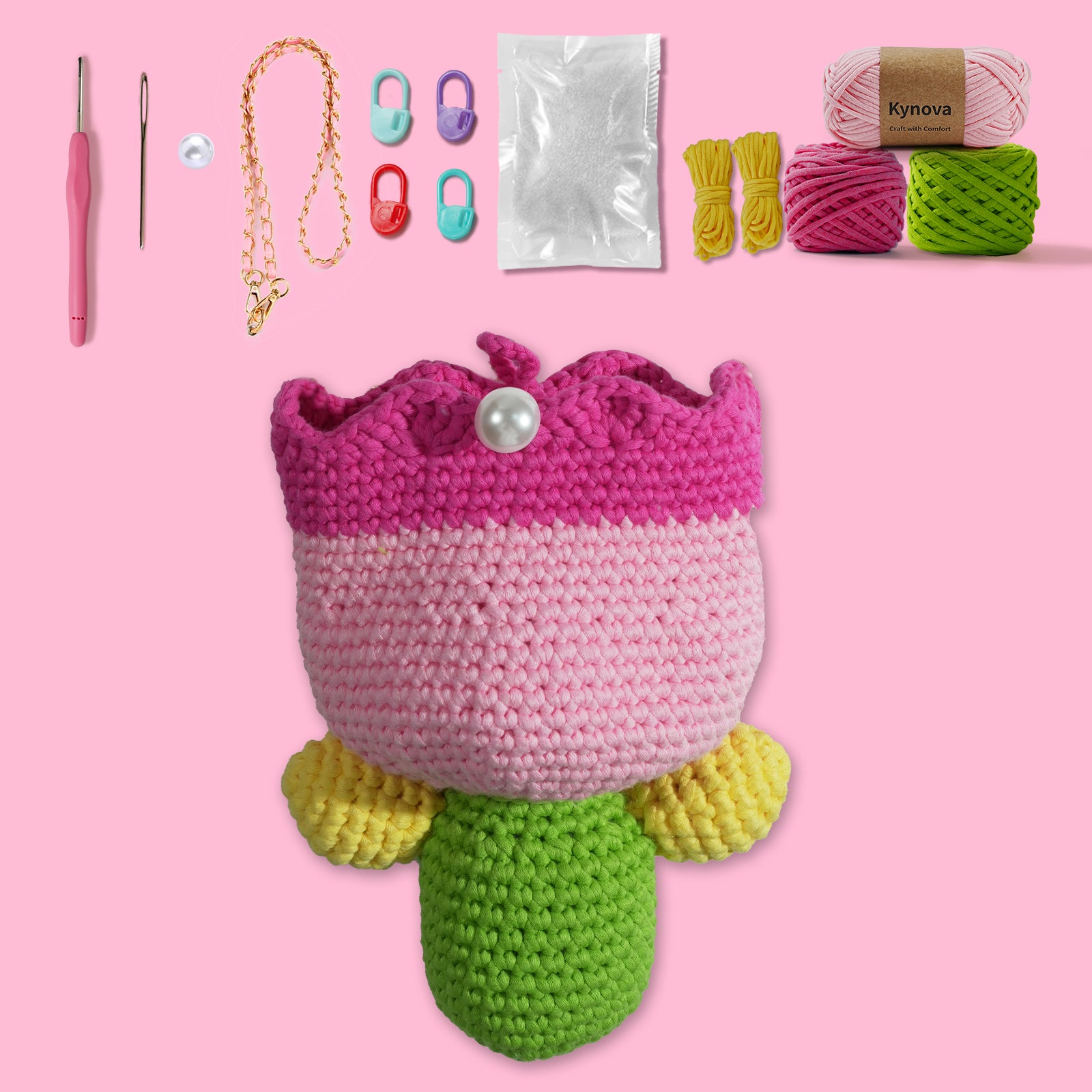 A collection of crafting materials including yarn in pink, green, and yellow, crochet hooks, and other accessories to create a tulip-shaped bag, displayed on a pink background.
